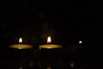 Light a candle in the darkness of Remembrance Day with numbers indicating the time.