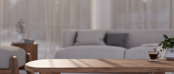 Fototapeta na wymiar Copy space on minimal wood coffee table in comfortable living room.