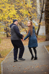 couple walking in autumn park