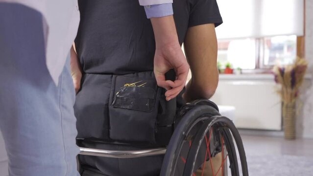 Young man moving in wheelchair in slow motion.
Disabled man in wheelchair in slow motion.
