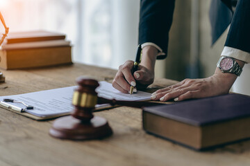 Legal services concepts at the Computer Labor Law Advising Office. lawyer working at the desk Hammer and scales on lawyer's table for justice