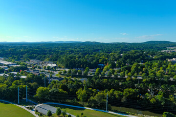 an aerial shot of the vast miles of lush green trees and grass with buildings nestled among the...