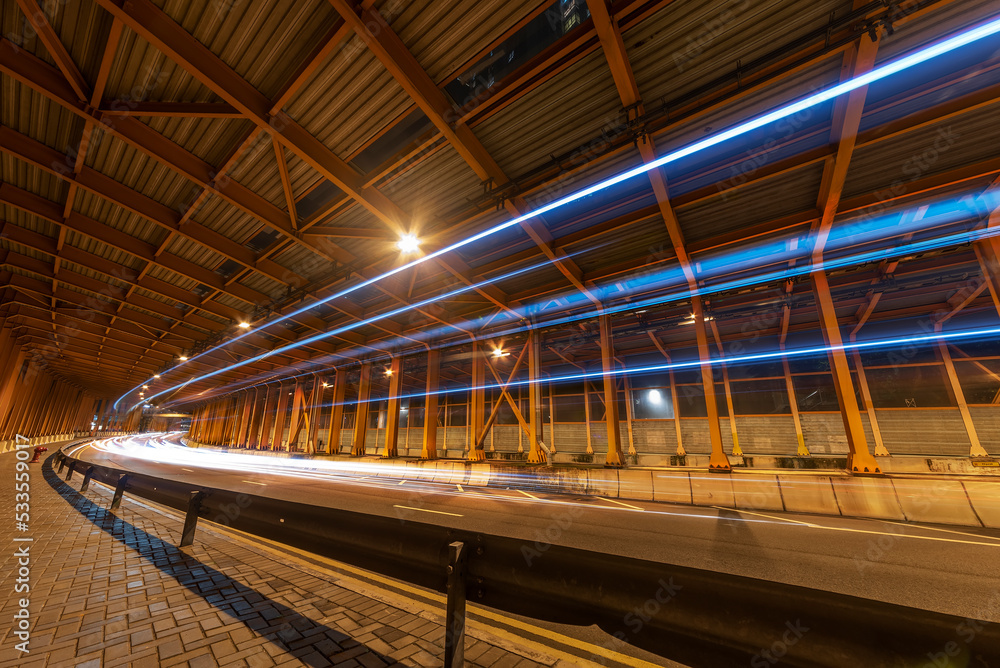 Poster light trails and head lights of traffic in tunnel. transportation background