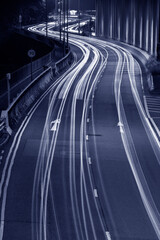 Fototapeta na wymiar Light trails of traffic on road at night. Transportation background