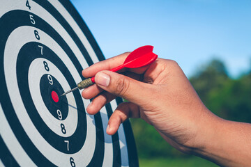 Bullseye has red dart arrow throw hitting the center of a shooting for business. targeting and winning goals business.