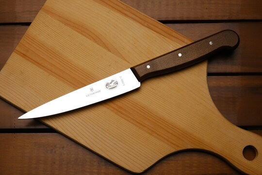 A picture of Victorinox wood handle carving knife on wooden table.