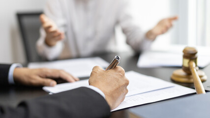 Client describes the money fraud problem and discusses the solution with a lawyer in the litigation room, Ethics in the courts include justice, legal consultant, Scales of justice, Litigation.
