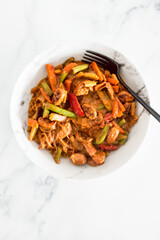 healthy plant-based food, vegan stir-fry vegetables with vermicelli noodles and satay sauce