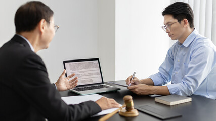 Lawyer or judge has recommend a client sign a legal agreement in the courtroom, Legal Agreement Documents and Business Litigation Forms, scales of justice, law hammer, Litigation and legal services.