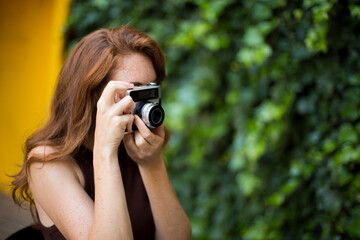 Beauty woman taking photos with a old fashioned camera