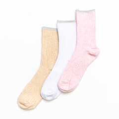 Various modern trendy women's cotton socks set on white background. Fashionable socks store. Socks shopping, sale, merchandise, advertisement concept. Flat lay, top view