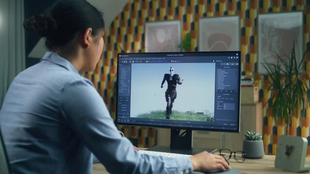 Asian female 3D designer making animation for video game character using modern computer with software for creating 3D modeling projects