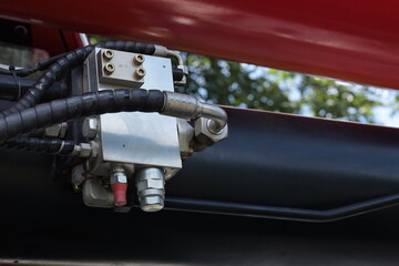 Crane hydraulic valve. Close-up view of hydraulic oil valve or crane gear-driven check valve with copy area in shallow focus view.