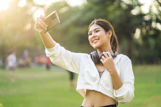 Portrait of smiling cheerful beautiful pretty asian woman clean fresh healthy white skin posing smile look at camera making live selfie on smartphone.Business and digital technology