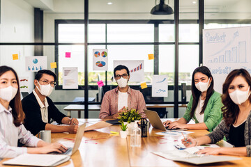 Group of asian business meeting and discussing strategy startup project analysis finance process.Success business people work plan and brainstorm marketing idea with laptop in office.Teamwork