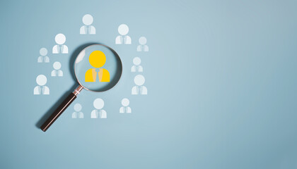 Magnifier glass focus to manager icon which is among staff icons for human resources, CRM, data mining and social media concept