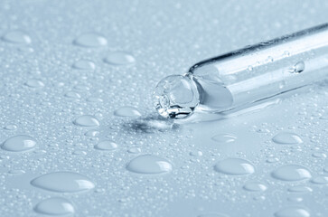 Micellar water drops and pipette. Cosmetic product for moisturizing the skin or removing makeup. Close-up, macro photography