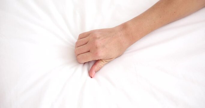 Female hand squeezing sheet during orgasm closeup 4k movie slow motion