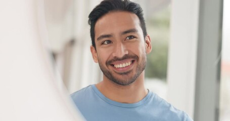 Smile, brushing teeth and man taking care of his dental health or oral hygiene while looking in the bathroom mirror. Happy asian man taking care of health and wellbeing with toothbrush and toothpaste - Powered by Adobe