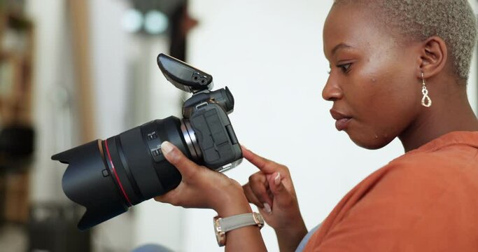 Photographer, fashion and photo shoot with a woman photography professional working on a camera in the studio. Creative, picture and catalog with a female employee working on a modeling campaign