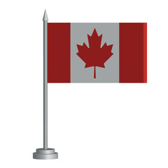 Fototapeta na wymiar Flag of Canada on a flagpole stands on the table