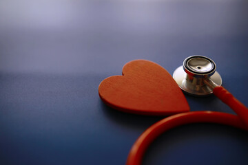 Doctor`s desk in the clinic's office. Stethoscope, puzzle heart, prescriptions on the table.