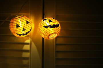 The concept of light on the night Halloween.Round lamp shape of pumpkin used to decorate with bokeh and copy space for text.