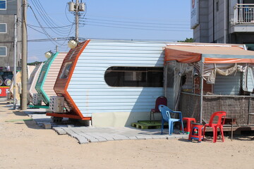 Blue beach trailer with plastic chairs