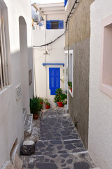 White houses with blue shutters, balconies, the traditional Greek village of Mandraki on the island of Nisyros.