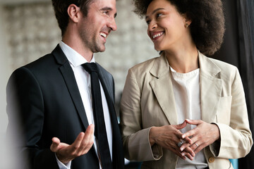 Portrait of businessman talking to woman colleague