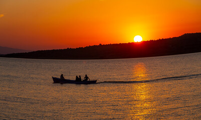 Fishermen casting nets in the lake