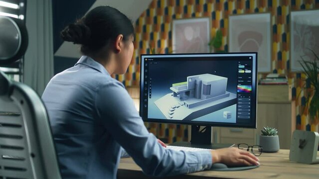 Female 3D designer at home working on 3D modeling project of house and creating exterior in professional computer program using pc