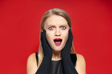 Concept of Halloween, young woman on red background