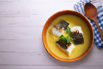 Bacalao al pil pil traditional tapa from the north of Spain. Coconut fish cooked with a delicious sauce made with oil, cod and garlic.
