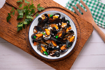 Steamed mussels with tomato sauce and feta cheese. Typical Greek recipe.