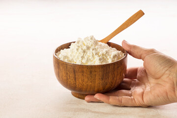 Corn flour in wooden bowl close up