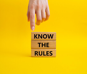 Know the rules symbol. Wooden blocks with words Know the rules. Beautiful yellow background....