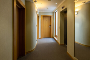 Interior of a hotel corridor with doors with room nummbers