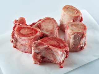 Beef Bones for Making Broth on white paper. Raw beef bones for soup.