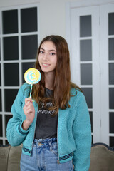 Teen girl with lollipop. Model.
