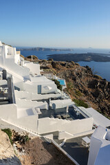 Whitewashed houses with terraces and pools and a beautiful view in Imerovigli on Santorini island, Greece