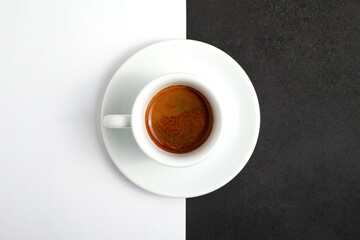A cup of espresso coffee on a black and white background. Coffee drink close up.