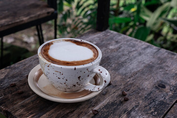 coffee latte heart art on the black wooden table