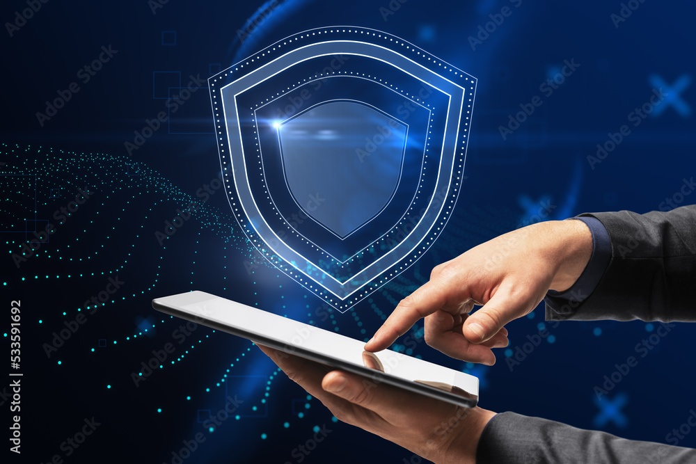 Poster businessman hand pointing at smartphone with creative glowing shield hologram on blue background wit