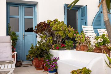 Flowers in ceramic pots in front of a whitewashed house in Imerovigli on Santorini island, Cyclades, Greece