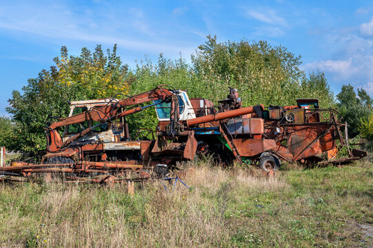 Old rusty agricultural machinery. Abandoned harvester, tractor