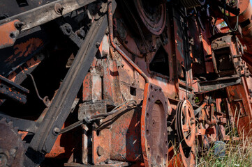 Old rusty agricultural machinery. Close-up Of Abandoned harvester, tractor