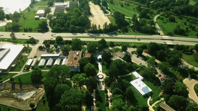 A panoramic shot of an autumn city park in morning time where sun rays are illuminates the garden. A perfect drone shot of Morton Arboretum park