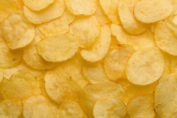 Potato chips with salt texture top view pattern background
