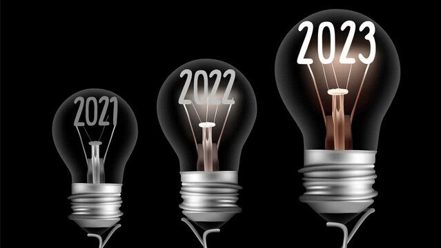 Shining light bulb with number 2023 and group of dark light bulbs in a row going from 2021 to 2022 isolated on black background. New Year concept. High quality 4k video.